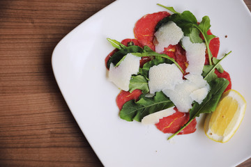 Beef Carpaccio cold appetizer with parmesan cheese italian food