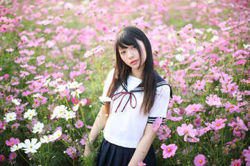 Portrait of Japanese school girl uniform with pink cosmos flower