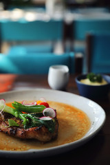 Grilled Porkchop and vegetables on top on wood background