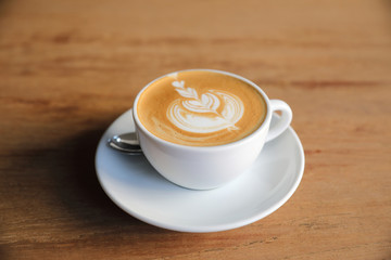 cappuccino or Latte art coffee made from milk on the wood table in coffee shop