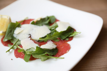 Beef Carpaccio cold appetizer with parmesan cheese italian food