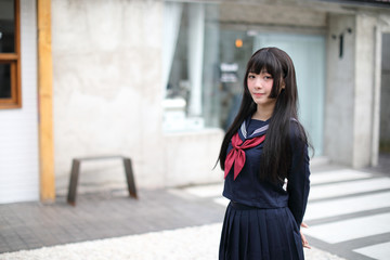Fototapeta premium Portrait japanese school girl in downtown ice cream shop