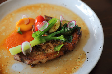 Grilled Porkchop and vegetables on top on wood background