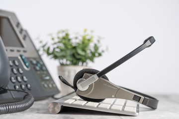 VOIP headset headphones telephone on office desk concept for communication, it support, call center...