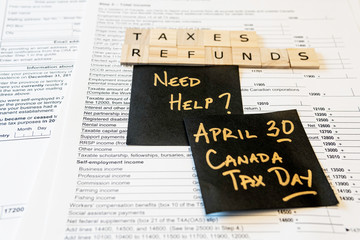 Naklejka premium New Canadian personal tax forms and letter tiles showing refunds and taxes