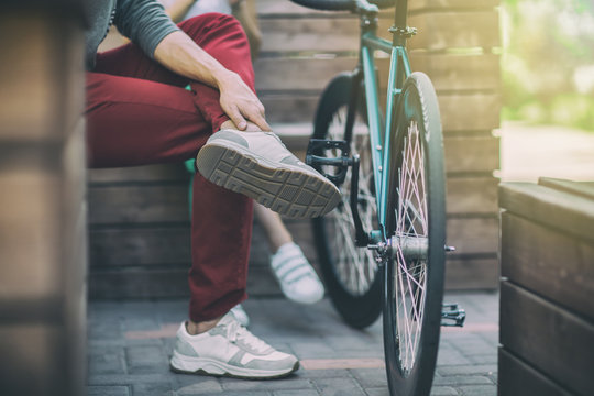 Young Man In Red Pants Next To The Track Bike