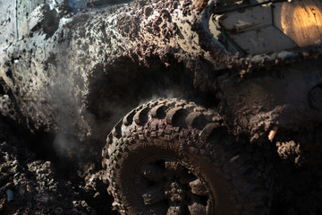 4x4 off-roading. Wheel close up in a countryside landscape with a muddy road. Offroad. Closeup...