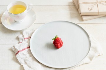 Health products. Green tea and strawberries. Food photo in high key. Tea set and gifts.