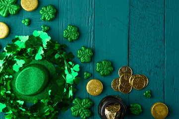 March 17, St. Patrick's Day.Irlandian holiday, Flat lay green background with coins, clover and hat.