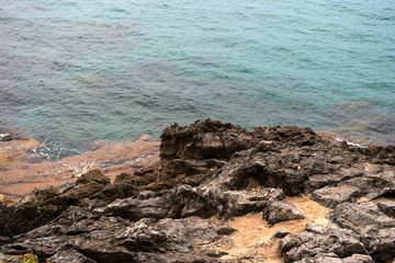 Rocky shore and water of the Mediterranean Sea on a summer day. Natural background