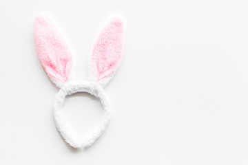 Easter bunny concept. Toy rabbit's ears for head on white background top-down copy space
