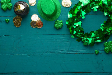Traditional Irish holiday St. Patrick's Day, March 17th celebration, with accessories for teething on a green wooden background.