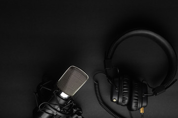 Podcasts and Stream. Flat lay. Studio condenser microphone black with professional headphones, top...