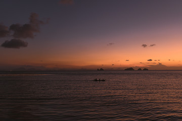 Beautiful sunset at the sea in Thailand on the island of Koh Samui. Sun, sea, beach, palm trees and waves. Spiritual pastime in the open air