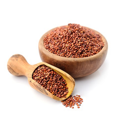 Real quinoa in a wooden bowl isolated on white
