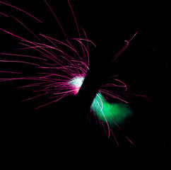 long sparks of fire on a black background