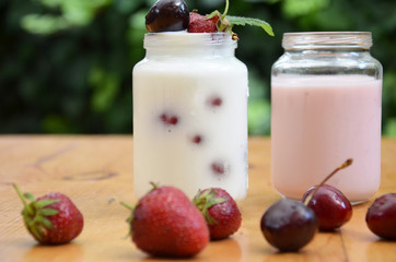 Healthy breakfast home made pudding or yogurt or granola, strawberries, cherry, honeysuckle berry,...
