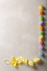 Easter background. Easter eggs on light concrete with copy space.