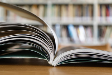 Opened book on a table in library