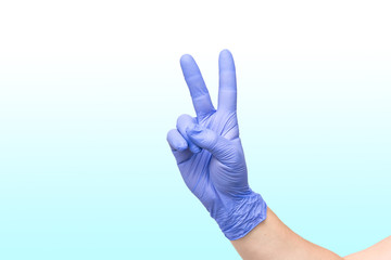 male hand on white blue gradient background showing the symbol of victory or the number two