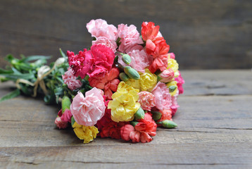 beautiful bouquet of colorful flowers carnation on a white table - obrazy, fototapety, plakaty