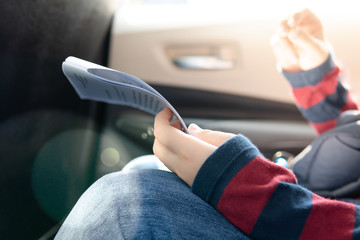 Closeup, Hands of teenage student hold scripts & screenplay, read out loud, memorize lines with concentration, pressure and stress in back seat of car, last minute preparation and rehearsal.