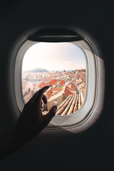 Airplane window with a aerial panorama of Old Town Dubrovnik, Croatia during a flight