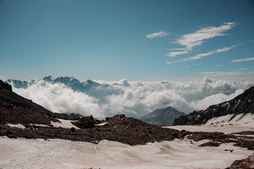 Mountain with the snow remnants on the brown rocks under clear sky