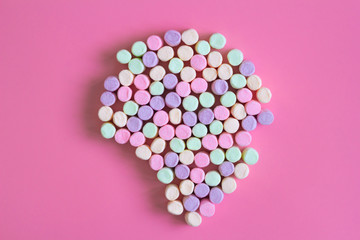 Colorful marshmallows on pink background, macro. Fluffy marshmallows texture close up in pastel colors