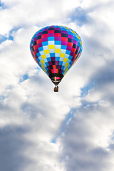 Low Angle View Of Hot Air Balloons Flying Against Cloudy Sky