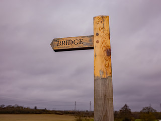 Close up of wooden bridge sign in the English countryside