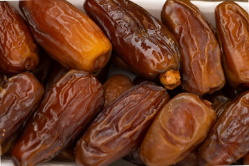 Benefits of Dates. Dried Dates on wooden background close up textured