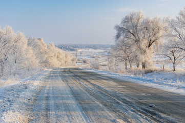 Fototapeta premium Winter landscape with country slippery road near Solone village in central Ukraine
