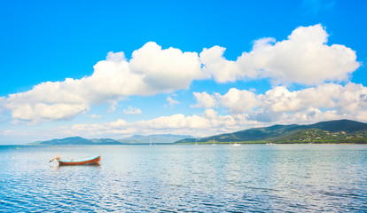 Fototapeta premium Small wooden boat in a sea bay. Punta Ala, Maremma Italy