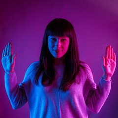 Young beautiful girl in a neon light.