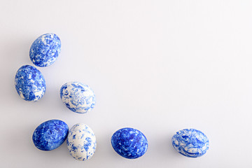top view Easter eggs in the color of the year-classic blue with gradient effect on white background