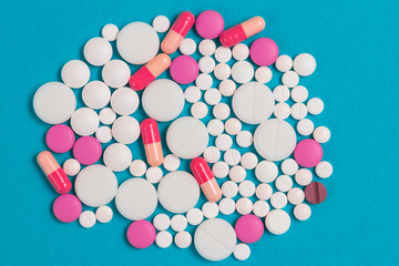 Pharmaceutical medicament background with different multicolored medicinal medicine pills, tablets, capsules, concept of drug abuse with copy space, top view