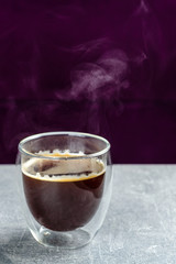 hot americano coffee in a glass with steam