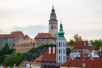 Obraz premium View of St. Jost Church at the foreground with Castle Tower at the background in Cesky Krumlov, Czech Republic