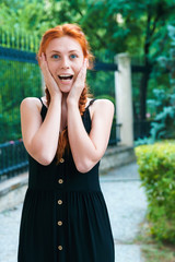 Beautiful ginger woman surprised by gift. Wedding proposal concept.