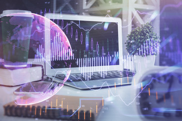 Financial chart drawing and table with computer on background. Double exposure. Concept of international markets.