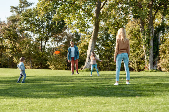 Its The Weekend. Enjoy It. Parents Playing Frisbee With Their Kids In The Park On A Sunny Day