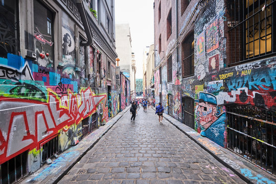 Graffiti, tourists and street artists packed into Hosier Lane in Melbourne CBD and lots of colourful art dedicated to Australian Bushfires