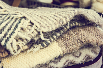 Fototapeta na wymiar A pile of warm wool scarves. winter comfort, winter inspiration, still life