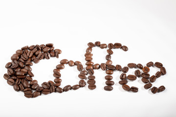 The word coffee written with coffee beans on a white background