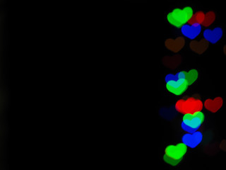 Blurred light colorful heart shaped on black background. Concept valentine's day,love,anniversary..