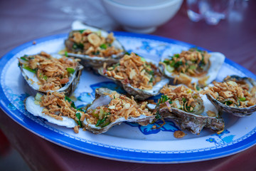 sea food, cooking seafood on a barbecue, shrimps, oysters, frog legs, squids, lobsters, close-up