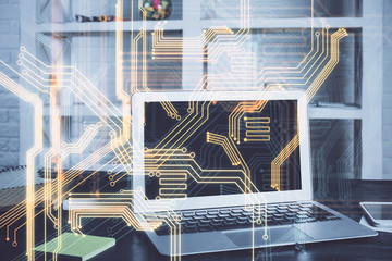 Computer on desktop in office with technology theme hologram. Multi exposure. Tech concept.