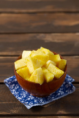 fresh pineapple pieces on wooden surface