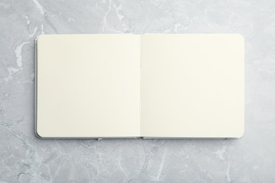 Flat lay of open blank empty spiral sketchbook notebook textbook
